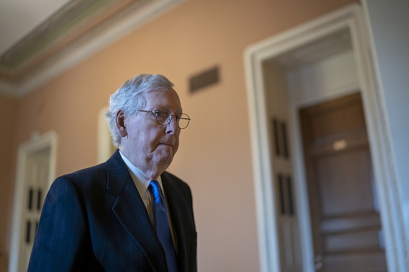 Senate Minority Leader Mitch McConnell, R-Ky., returns to his office as work continues on the process to raise the debt limit, at the Capitol in Washington, Thursday, Dec. 9, 2021. (AP Photo/J. Scott Applewhite)