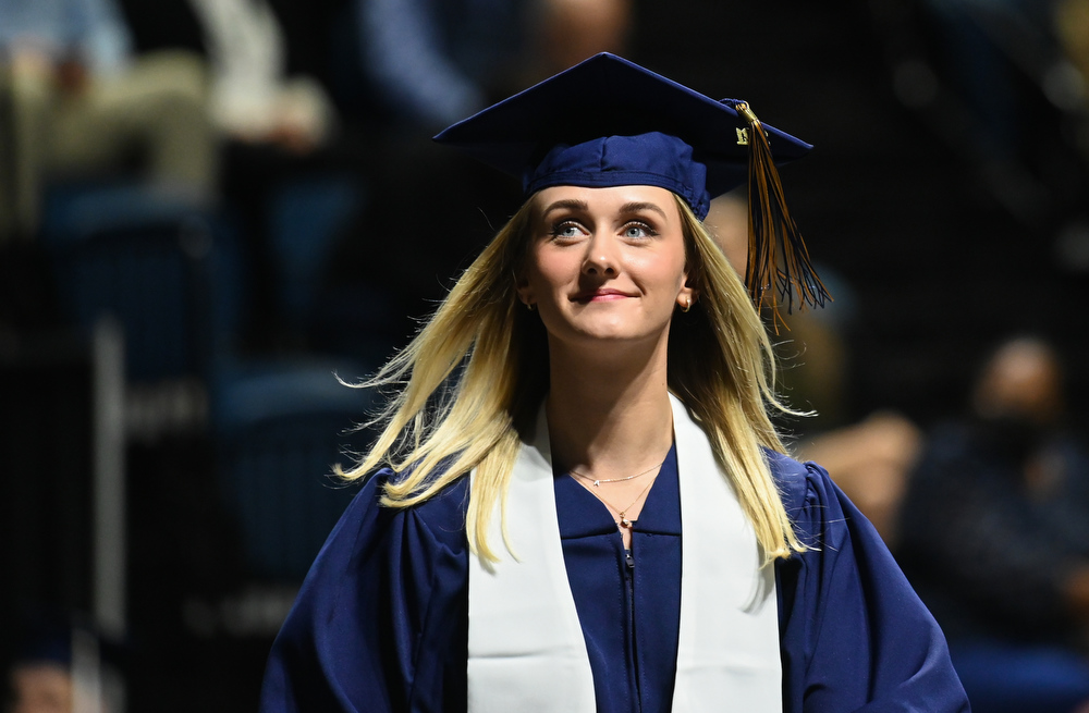 Olivia Ross crosses the stage during the first of two graduation ceremonies for undergraduate students on Saturday, Dec. 11, 2021 in McKenzie Arena. / Photo by Angela Foster