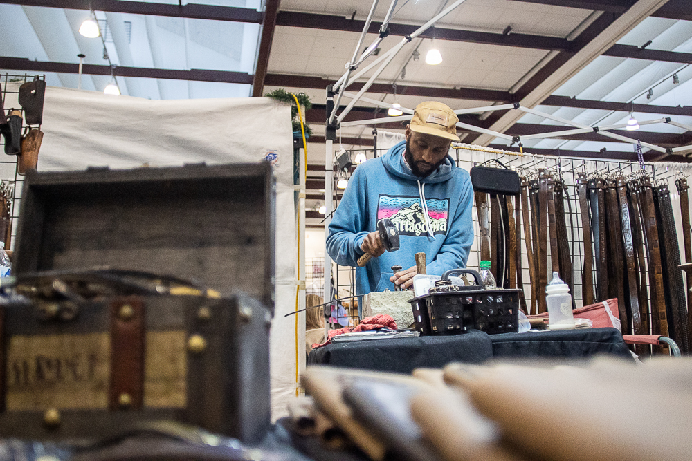 Staff photo by Troy Stolt / Chris Dickerson makes belts at The Leather Underground booth during the Holiday Market at the Chattanooga Convention Center on Saturday, Dec. 11, 2021.