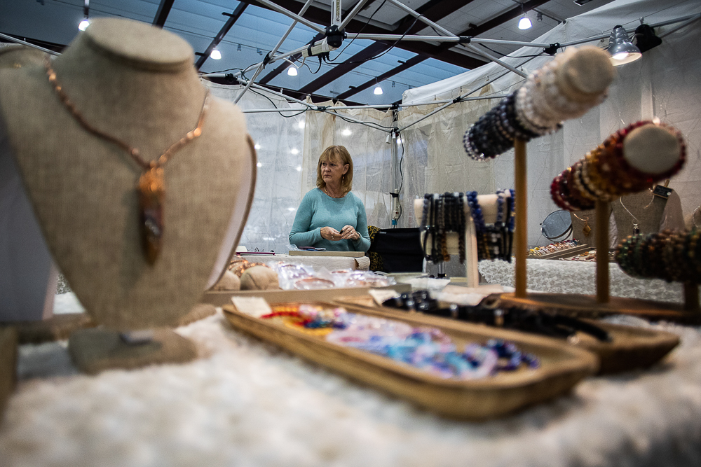 Staff photo by Troy Stolt / Brenda Forsythe of Lilly Pond Lapidary stands in her booth during the Holiday Market at the Chattanooga Convention Center on Saturday, Dec. 11, 2021.