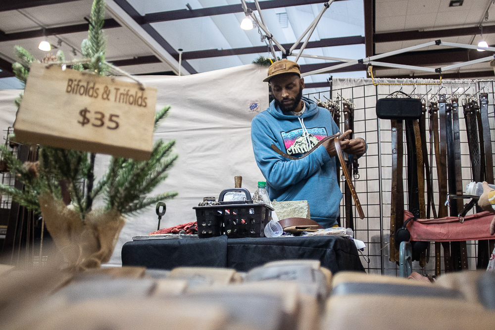 Staff photo by Troy Stolt / Chris Dickerson makes belts at The Leather Underground booth during the Holiday Market at the Chattanooga Convention Center on Saturday, Dec. 11, 2021.