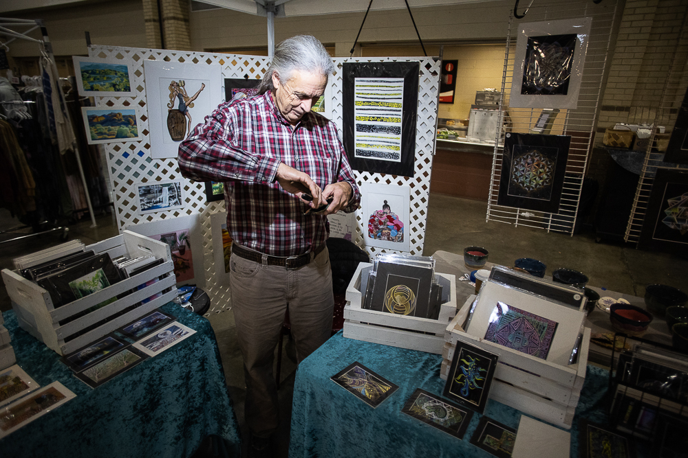 Staff photo by Troy Stolt / Jack Pickett finishes an ornament to sell at his booth during the Holiday Market at the Chattanooga Convention Center on Saturday, Dec. 11, 2021.