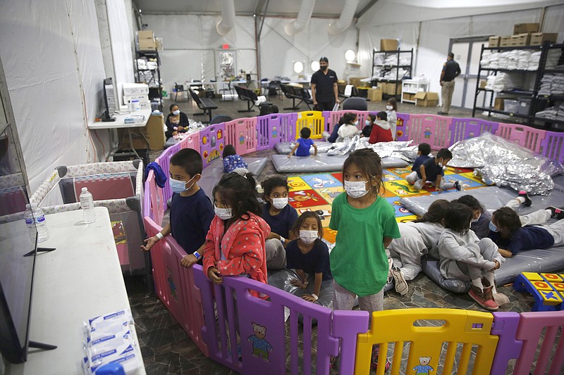 AP File Photo/Dario Lopez-Mills / Young illegal immigrant children, ages 3 to 9, watch television inside a playpen at the U.S. Customs and Border Protection facility, the main detention center for unaccompanied children in the Rio Grande Valley, in Donna, Texas, in March.