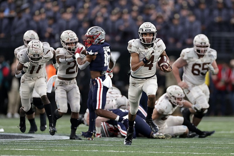 Army quarterback Christian Anderson (4) runs for a touchdown against Navy during the first half of an NCAA college football game Saturday, Dec. 11, 2021, in East Rutherford, N.J. (AP Photo/Adam Hunger)