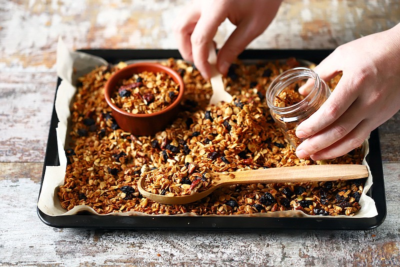 Freshly made homemade granola on a baking sheet. / Getty Images/iStock/Oksana Shyriaieva