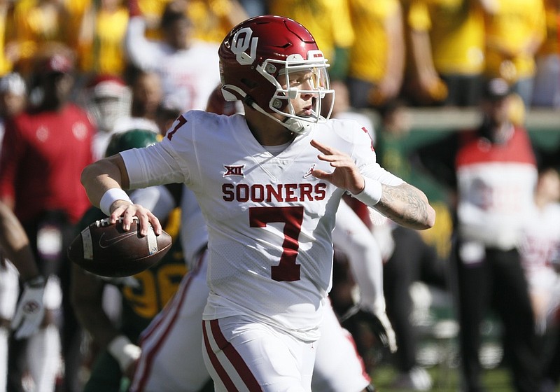 FILE - Oklahoma quarterback Spencer Rattler looks to throw down field against Baylor during the second half of an NCAA college football game in Waco, Texas, Saturday, Nov. 13, 2021. (AP Photo/Ray Carlin)