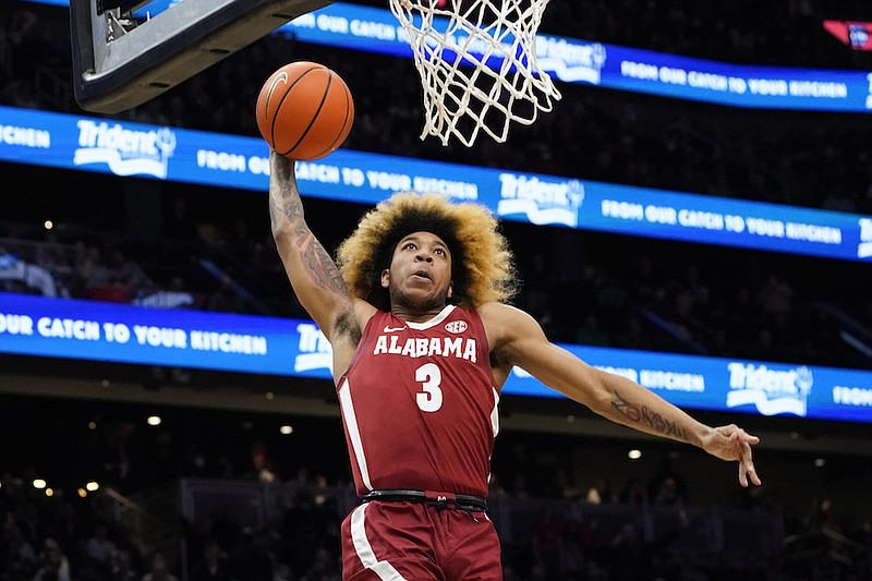 Alabama's JD Davison heads toward the basket for a dunk against Gonzaga during the second half of an NCAA college basketball game Saturday, Dec. 4, 2021, in Seattle. Alabama won 91-82. (AP Photo/Elaine Thompson)