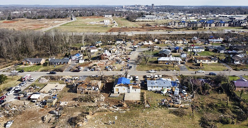 Photo by Grace Ramey/Bowling Green Daily News via The Associated Press / Residents, organizations and volunteers clear belongings and debris from homes destroyed in the Creekwood subdivision by the Dec. 11 tornadoes on Hillridge Court in Bowling Green, Ky., on Wednesday, Dec. 15, 2021.