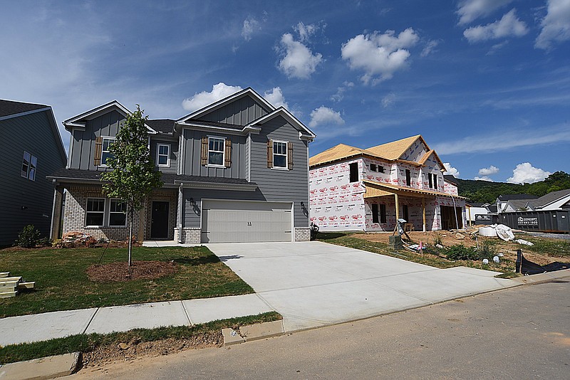 Staff Photo by Matt Hamilton / Finished homes sit next to homes under construction on Highborne Lane in Ooltewah on Wednesday, June 30, 2021. 