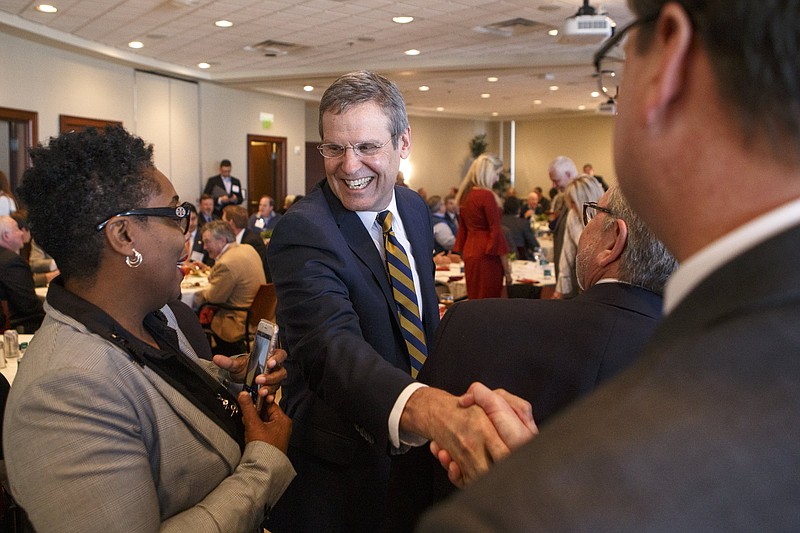 Staff file photo / Gov. Bill Lee, center, greets city council members Darrin Ledford, right, and Demetrus Coonrod during a Chattanooga Area Chamber of Commerce luncheon at the EPB building downtown on March 22, 2019, in Chattanooga, Tenn.