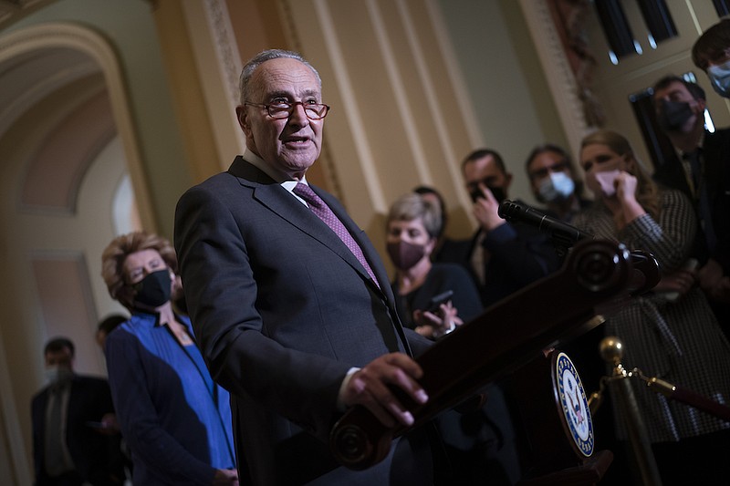 Senate Majority Leader Chuck Schumer, D-N.Y., speaks to reporters after a Democratic policy meeting at the Capitol in Washington, Tuesday, Dec. 14, 2021. (AP Photo/J. Scott Applewhite)