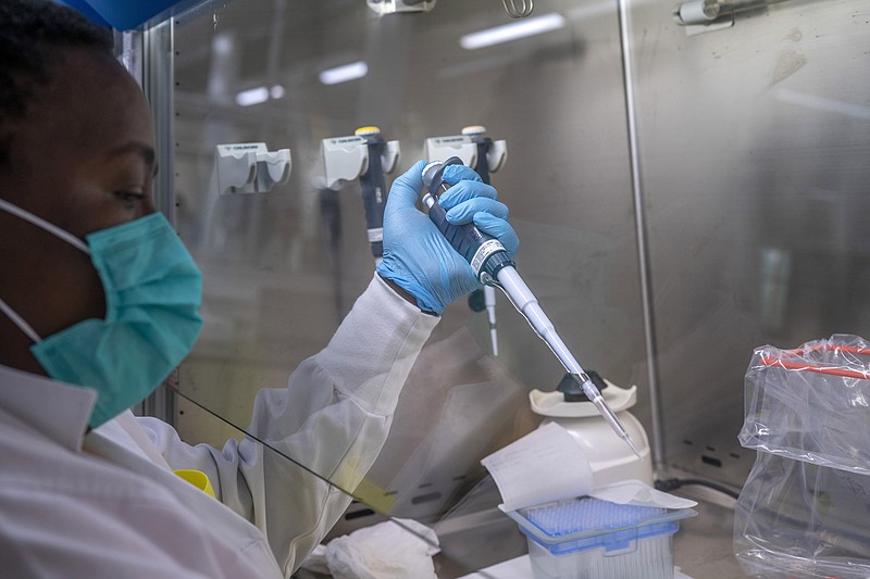 FILE — Puseletso Lesofi prepares to sequence COVID-19 omicron samples at the Ndlovu Research Center in Elandsdoorn, South Africa, Dec. 8, 2021. Health experts still don't know if omicron is causing milder COVID-19 but some more hints are emerging with doctors in South Africa saying their patients aren't getting as sick with omicron, compared to the delta variant. (AP Photo/Jerome Delay, File)