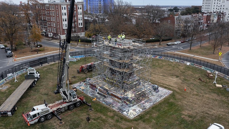 Workers begin the disassembly of the pedestal that once held the statue of Confederate General Robert E. Lee on Monument Avenue Wednesday Dec 8, 2021, in Richmond, Va. Virginia Gov. Ralph Northam ordered the pedestal removed and the land granted to the City of Richmond. (AP Photo/Steve Helber)


