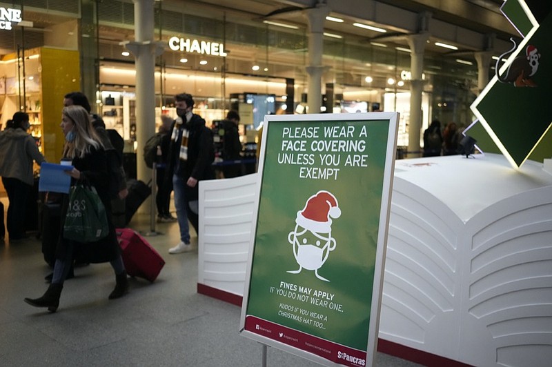 A sign asking people to wear face coverings to curb the spread of coronavirus at London St Pancras International rail station, in London, the Eurostar hub to travel to European countries including France, Friday, Dec. 17, 2021. (AP Photo/Matt Dunham)


