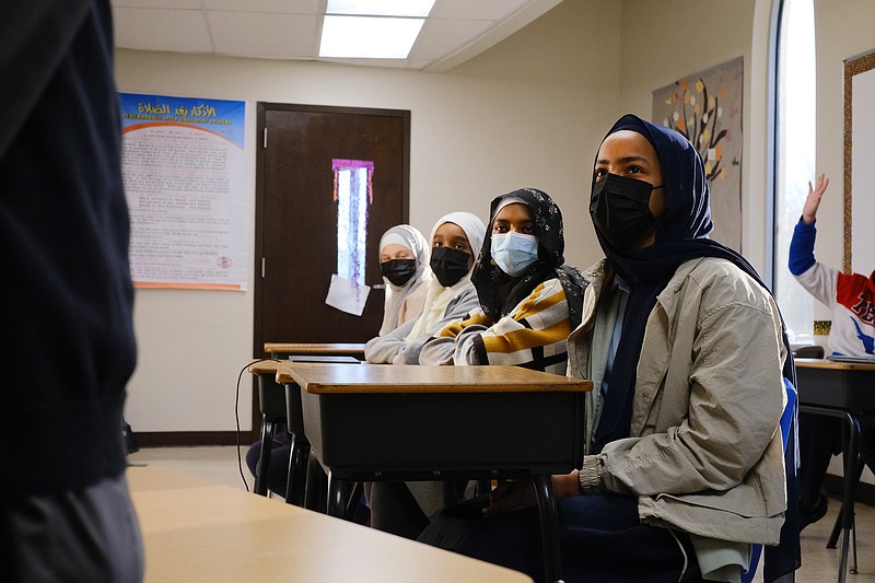 Staff photo by Wyatt Massey / Haneen Ahmed, far right, 13, watches her teacher at Annoor Academy on Dec. 14, 2021, in Chattanooga.