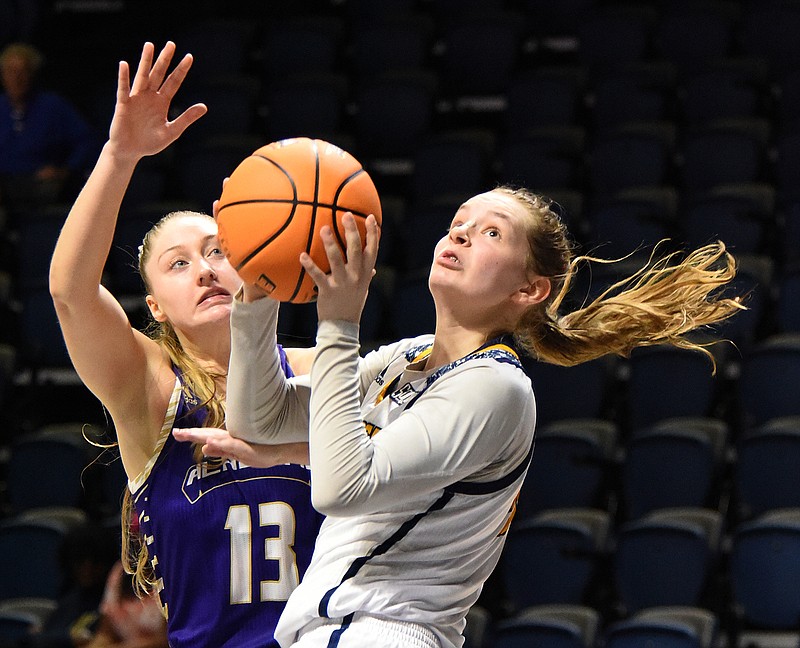 Staff photo by Matt Hamilton / UTC's Sigrun Olafsdottir shoots as North Alabama's Julia Strachan defends during Saturday's game at McKenzie Arena. North Alabama won 74-71, with Strachan's 25 points leading all scorers.