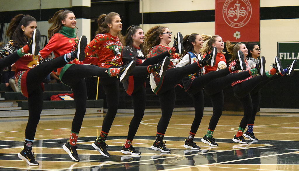 Staff Photo by Matt Hamilton / The Irish Charms dance team perform a routine dressed in Christmas sweaters during halftime of the Notre Dame High School basketball game against Baylor on Friday, December 17, 2021.