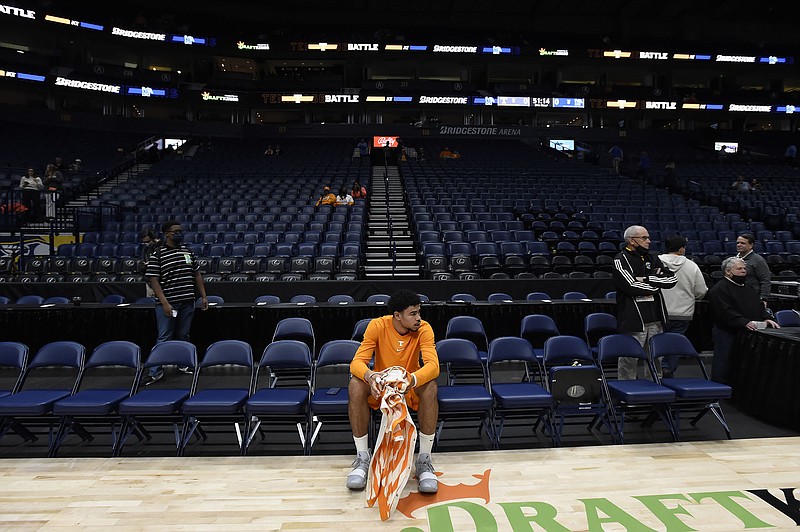 AP photo by Mark Zaleski / Tennessee forward Olivier Nkamhoua sits on the sideline at Bridgestone Arena after Saturday's basketball game between the Vols and Memphis was canceled due to COVID-19 protocols for the Tigers.