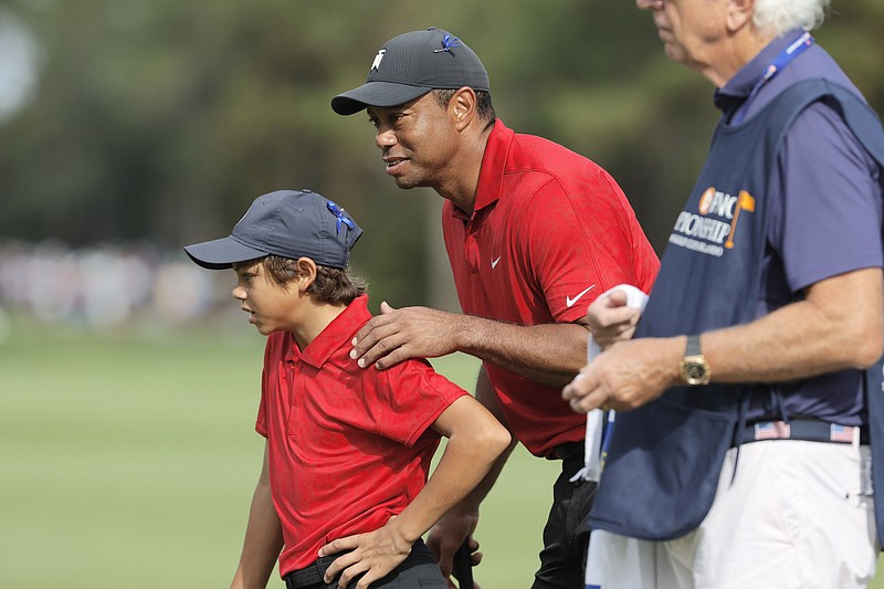 AP photo by Scott Audette / Tiger Woods talks with his son Charlie on the second green at the Ritz-Carlton Golf Club Orlando during the final round of the PNC Championship on Sunday.