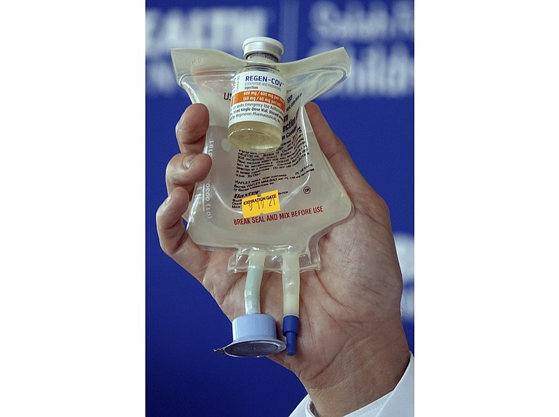 Dr. Aldo Calvo, Medical Director of Family Medicine at Broward Health, shows a Regeneron monoclonal antibody infusion bag during a news conference, Aug. 19, 2021 at the Hospital in Fort Lauderdale, Fla. As strained U.S. hospitals brace for a new surge of omicron COVID-19 cases, doctors are warning of yet another challenge: the two standard drugs they've used to treat early coronavirus infections are unlikely to work against the new variant. For more than a year antibody drugs from Regeneron and Eli Lilly have been the go-to treatments for COVID-19, thanks to their ability to head off severe disease and keep patients out of the hospital. (Joe Cavaretta/South Florida Sun-Sentinel via AP, File)