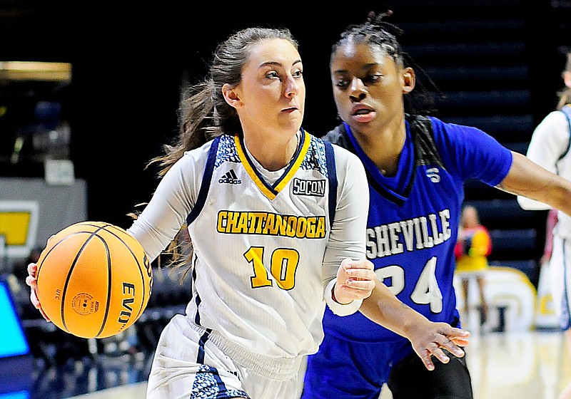 Staff Photo by Robin Rudd /  UTC's Dean Jarrells (10) drives past Asheville's Kai Carter (24).  The University of Tennessee at Chattanooga Mocs hosted the University of Asheville in NCAA women's basketball at McKenzie Arena on December 20, 2021.