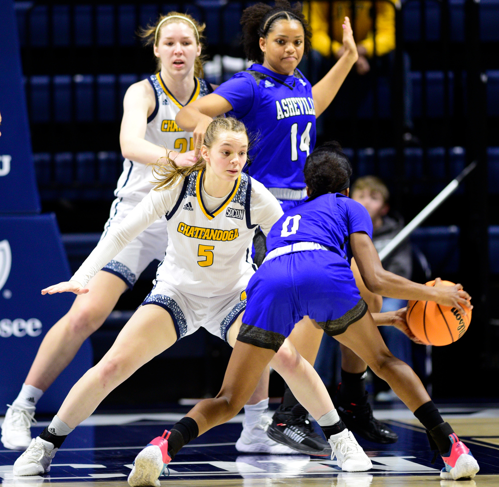 Staff Photo by Robin Rudd / UTC's Sigurn Olafsdottir (5) guards Asheville's Nadiria Evans (5), while teammate Abbey Cornelius (25) defends Asheville's Amanda Blake (14). The University of Tennessee at Chattanooga Mocs hosted the University of Asheville in NCAA women's basketball at McKenzie Arena on December 20, 2021.