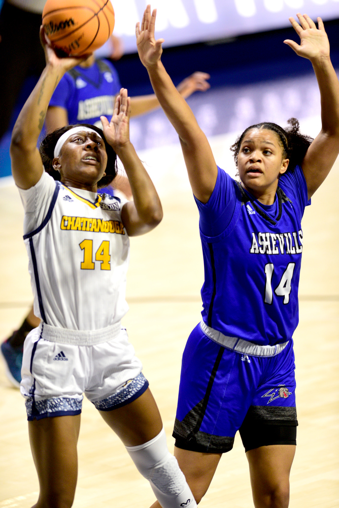Staff Photo by Robin Rudd / UTC's Amaria Pugh (14) scores against Asheville's Amanda Blake (14). The University of Tennessee at Chattanooga Mocs hosted the University of Asheville in NCAA women's basketball at McKenzie Arena on December 20, 2021.