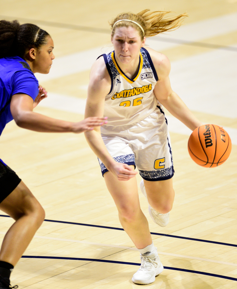 Staff Photo by Robin Rudd / UTC's Abbey Cornelius (25) dribbles past a Bulldog defender. The University of Tennessee at Chattanooga Mocs hosted the University of Asheville in NCAA women's basketball at McKenzie Arena on December 20, 2021.