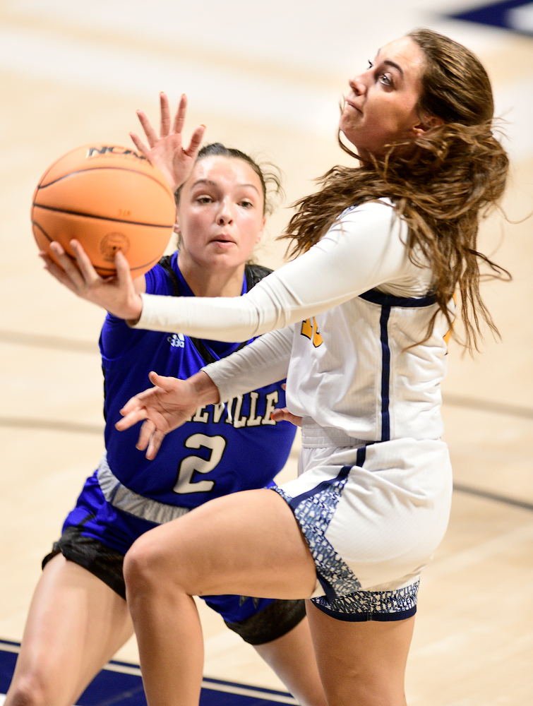 Staff Photo by Robin Rudd / UTC's Dena Jarrells (10) scores on a layup past Asheville's Faith Adams (2). The University of Tennessee at Chattanooga Mocs hosted the University of Asheville in NCAA women's basketball at McKenzie Arena on December 20, 2021.