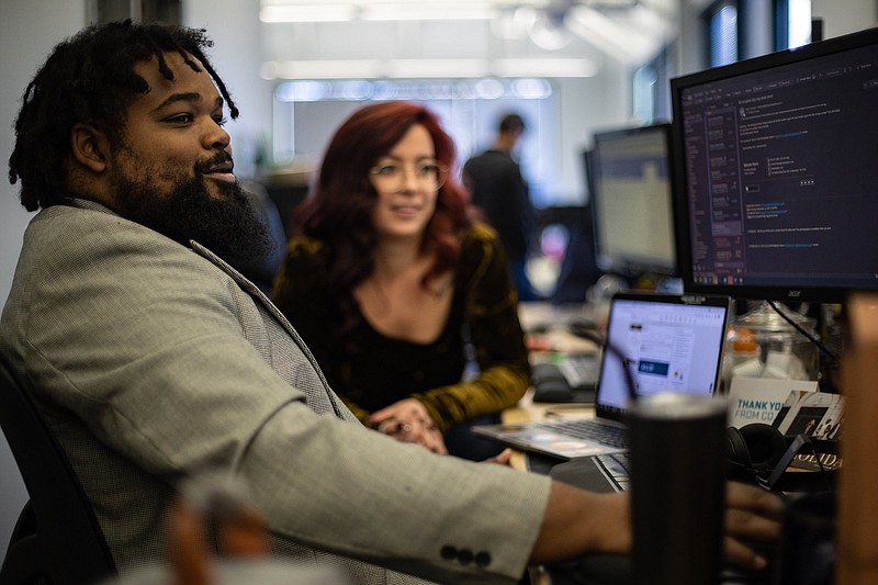 Staff photo by Troy Stolt / Malcolm Harris, director of culture and brand experience at Steam Logistics speaks with Recruitment Coordinator Madison MacDermaid in Steam's Market Street offices.