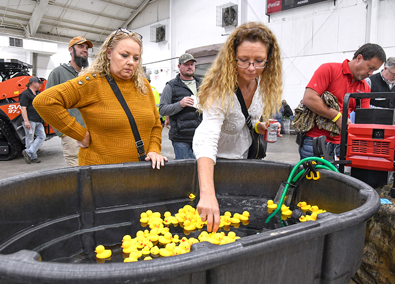 Photo by Mark Gilliland / Mitzi Thompson and Kim Pitchford pull ducks at the Milwaukee Tool table.