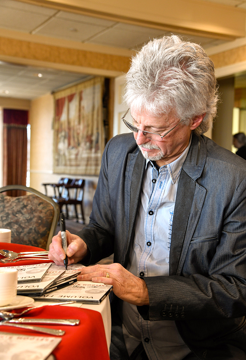 Photo by Mark Gilliland / Nashville songwriter Steve Dean signs CDs.
