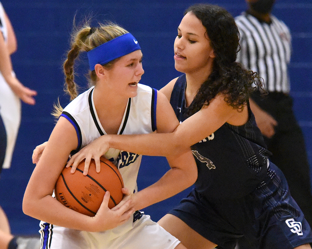 Staff Photo by Matt Hamilton / Soddy Daisy (4) Adyson Collins attempts to steal the ball as Sale Creek (21) Molly Welch tries to maintain control of the ball on Tuesday, December 21, 2021 during the championship game of the Sale Creek Christmas basketball tournament. Soddy Daisy went on to win 56-43.