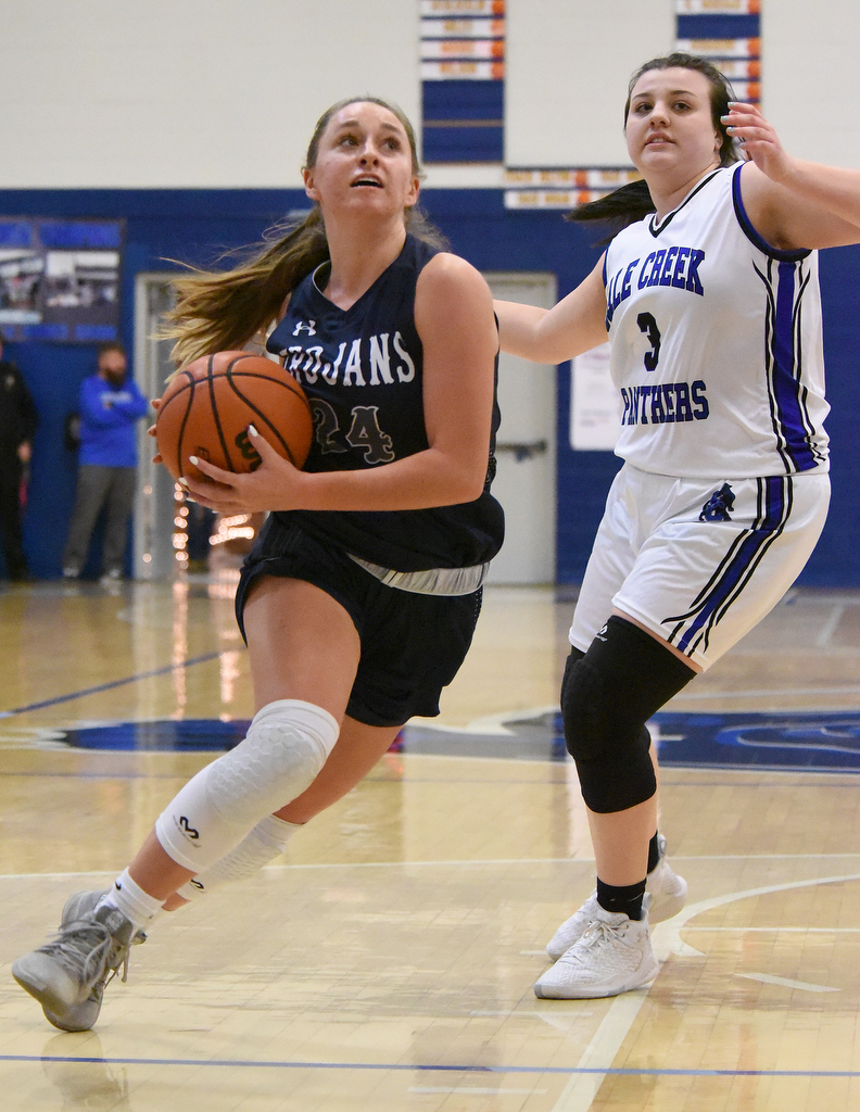 Staff Photo by Matt Hamilton / Soddy Daisy (24) Cam Varner drives to the hoop as Sale Creek (3) Kayla Phillips defends on Tuesday, December 21, 2021 during the championship game of the Sale Creek Christmas basketball tournament. Soddy Daisy went on to win 56-43.