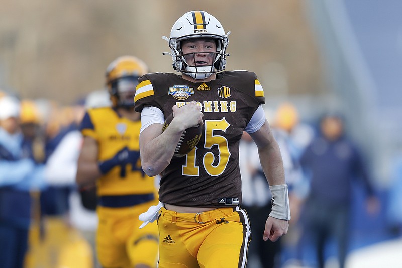 Wyoming quarterback Levi Williams runs down the sideline on a 50-yard touchdown run against Kent State during the first half of Tuesday's Idaho Potato Bowl.