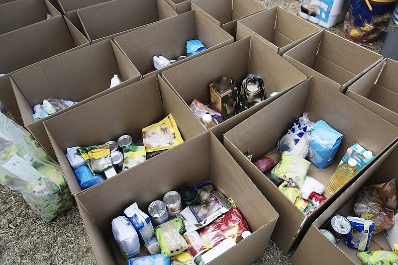 Cardboard boxes being filled with food donations for coronavirus disaster relief. / Getty Images/iStock/brazzo