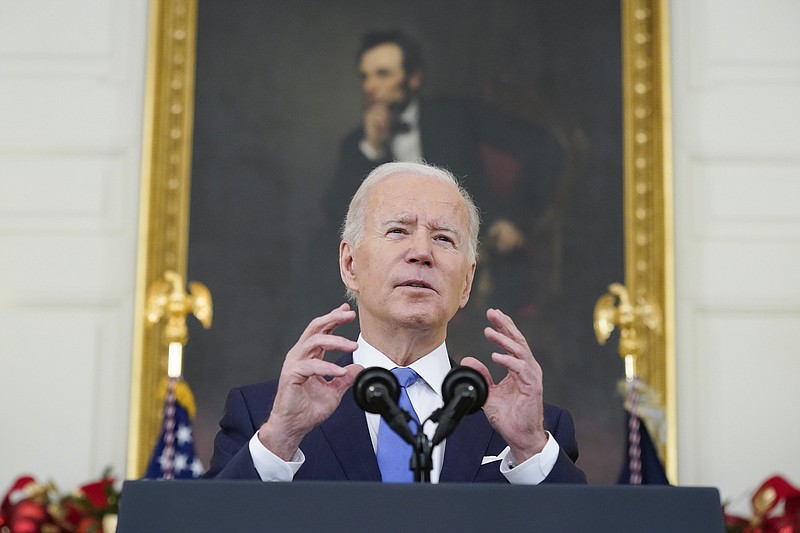 Photo by Patrick Semansky of The Associated Press / President Joe Biden speaks about the COVID-19 response and vaccinations on Tuesday, Dec. 21, 2021, in the State Dining Room of the White House in Washington.