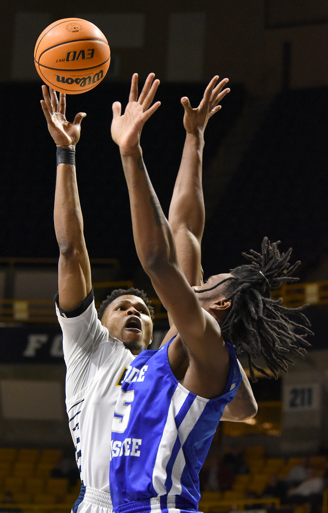Staff Photo by Matt Hamilton / Middle Tennessee State (15) Christian Fussell defends UTC (21) Josh Ayeni as he puts up a shot on Wednesday, December 22, 2021 at McKenzie Arena.