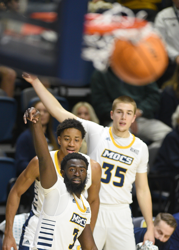 Staff Photo by Matt Hamilton / UTC (3) David Jean-Baptiste watches his three-point shot hit the bottom of the net with his teammates on Wednesday, December 22, 2021 at McKenzie Arena.