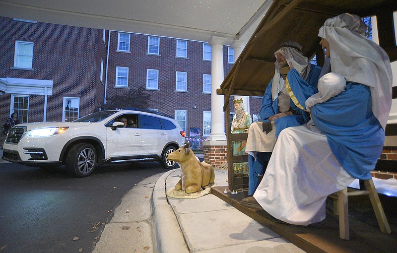 Staff Photo by Matt Hamilton / Jeffery and Katie Tatum portray Joseph and Mary as they wave to people at a drive-through Nativity scene at Dalton First United Methodist Church earlier this month.