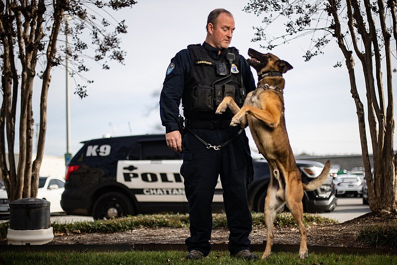 Staff photo by Troy Stolt / Officer Lucas Timmons and his K-9 Burt pose for a portrait at Chattanooga Police Department Headquarters on Monday, Dec. 20, 2021 in Chattanooga, Tenn.