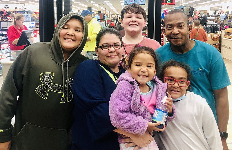 Contributed photo / Felicia Pace, middle, is pictured hugging her daughter Sophia, 4, while surrounded by her family, including Jakobe, 11, far left; Dean, 13, back; Malaika, 10, bottom; and David, right.