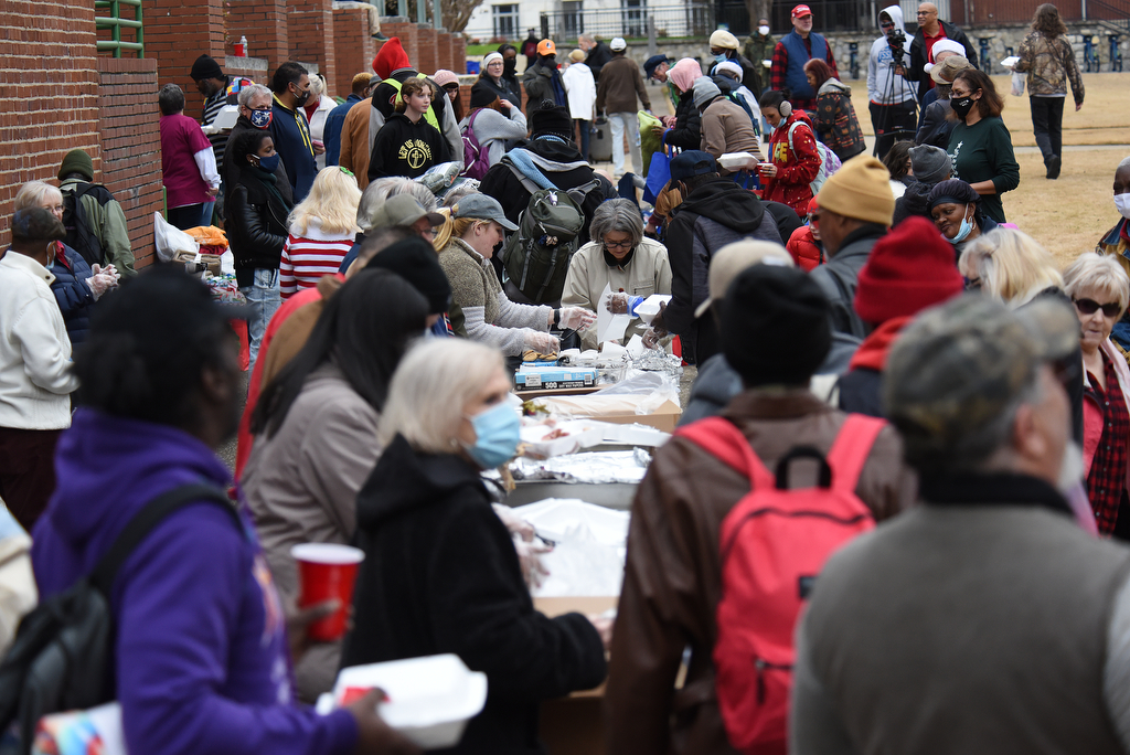 Staff Photo by Matt Hamilton / Volunteers distribute food and clothing at the Bessie Smith Cultural Center on Friday, December 24, 2021.