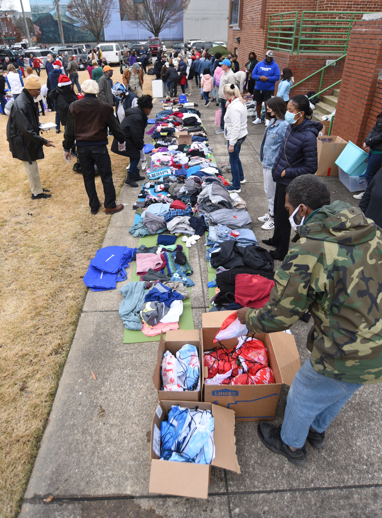 Staff Photo by Matt Hamilton / Volunteers lay out clothing to be given away at the Bessie Smith Cultural Center on Friday, December 24, 2021.