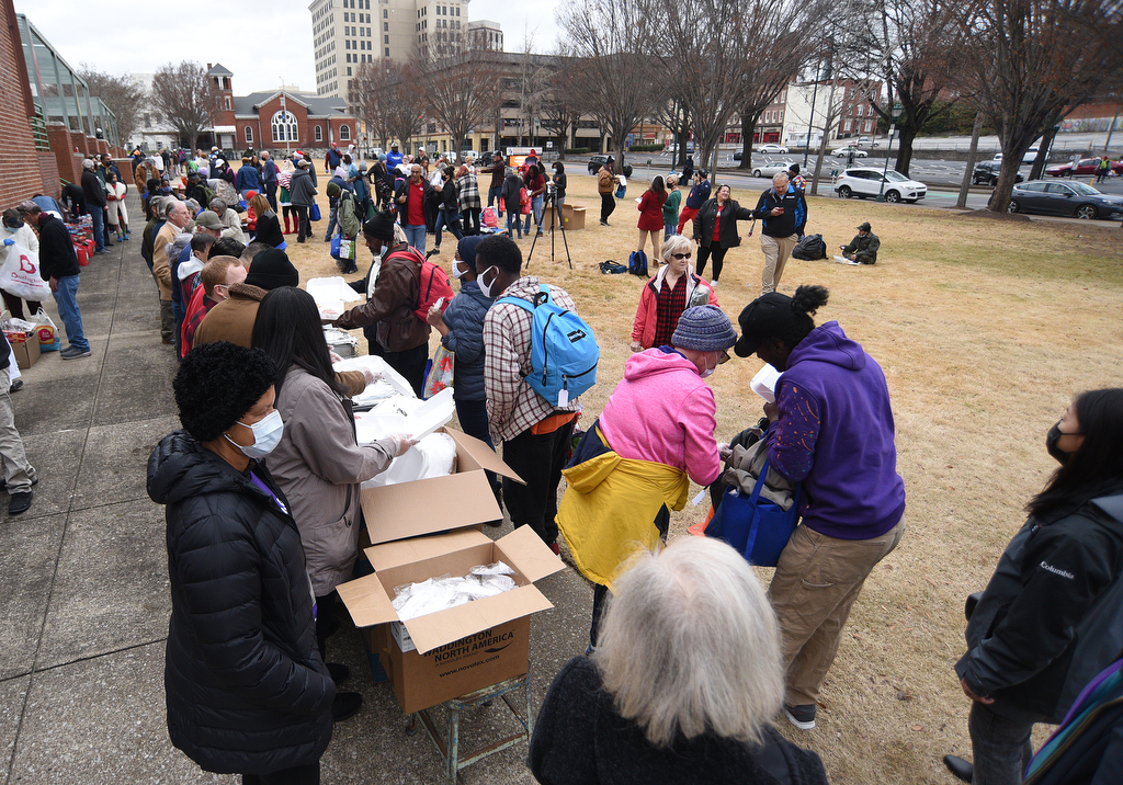 Staff Photo by Matt Hamilton / Volunteers distribute food and clothing at the Bessie Smith Cultural Center on Friday, December 24, 2021.