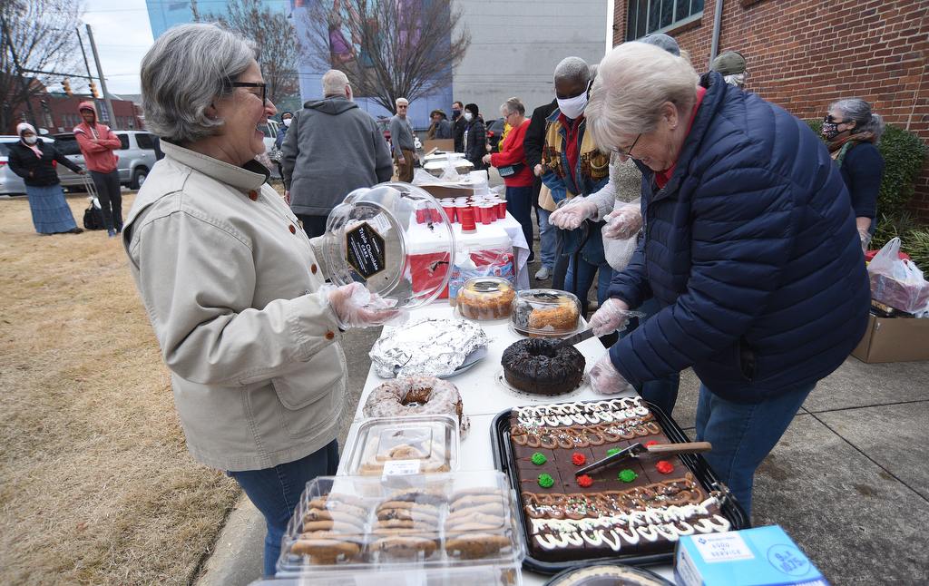 Staff Photo by Matt Hamilton / Susan Galloway, left, and Linda Russell prepare desserts at the Bessie Smith Cultural Center on Friday, December 24, 2021.
