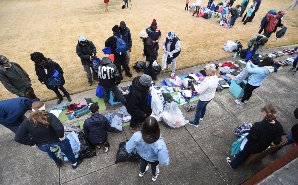 Staff Photo by Matt Hamilton / Volunteers lay out clothing to be given away at the Bessie Smith Cultural Center on Friday, December 24, 2021.