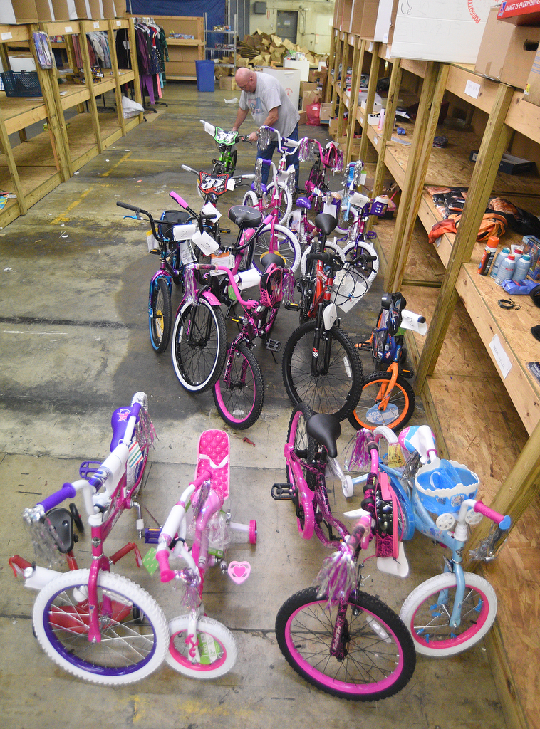 Staff Photo by Matt Hamilton / Dr. Troy Smith lines up bikes at the Forgotten Child Fund warehouse on Friday, December 24, 2021.