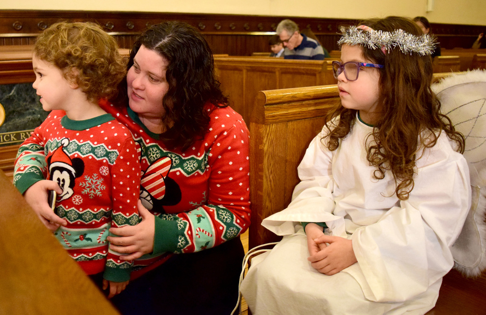 Staff Photo by Robin Rudd / From left, Sammy, mom Ruth and Ella Berry, look at the Nativity Scene before the service. The Vigil Mass of Christmas was celebrated at the Basilica of Saints Peter and Paul on December 24, 2021.