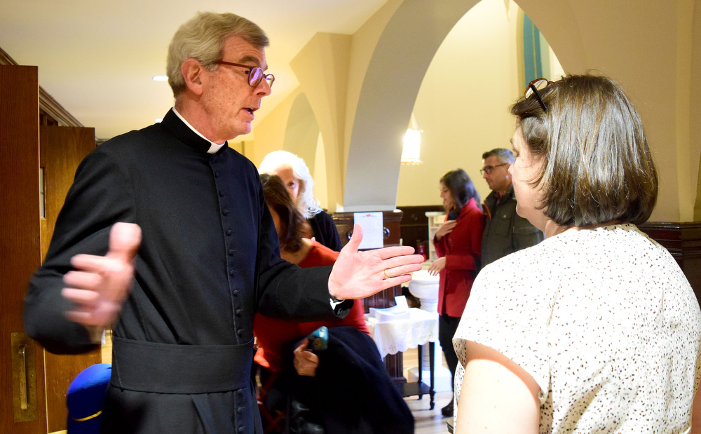 Staff Photo by Robin Rudd / Deacon Hicks Armor confers with Florence Porter before the service. The Vigil Mass of Christmas was celebrated at the Basilica of Saints Peter and Paul on December 24, 2021.